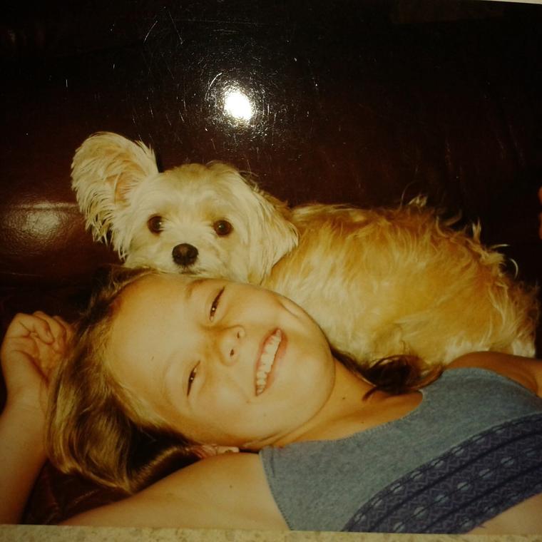 Young Amy lying on a couch with Blossom resting on her shoulder